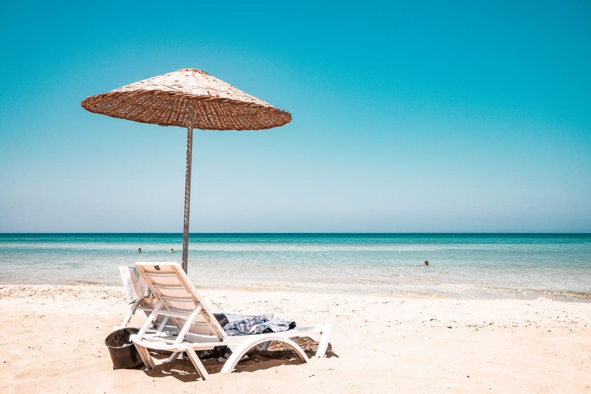 A reclining beach lounger on sand