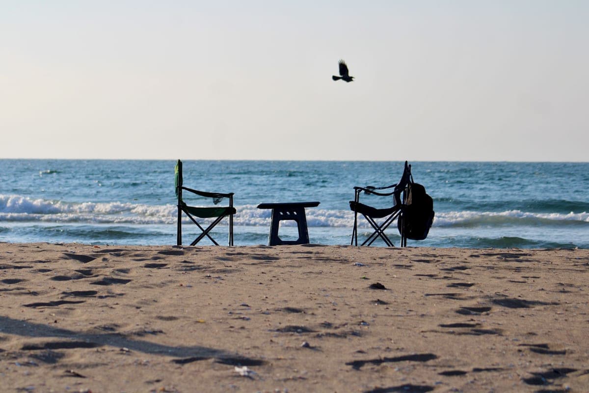 A folding beach chair facing the sea