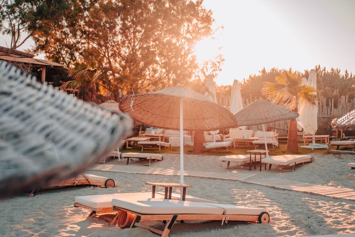 Two beach umbrellas side by side on sand