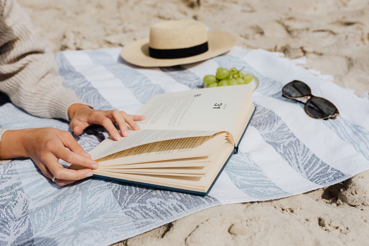 Someone reading in the shade on a beach