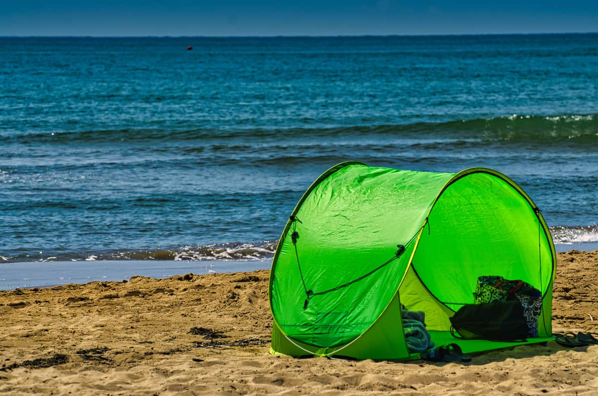 A beach tent pitched on sand